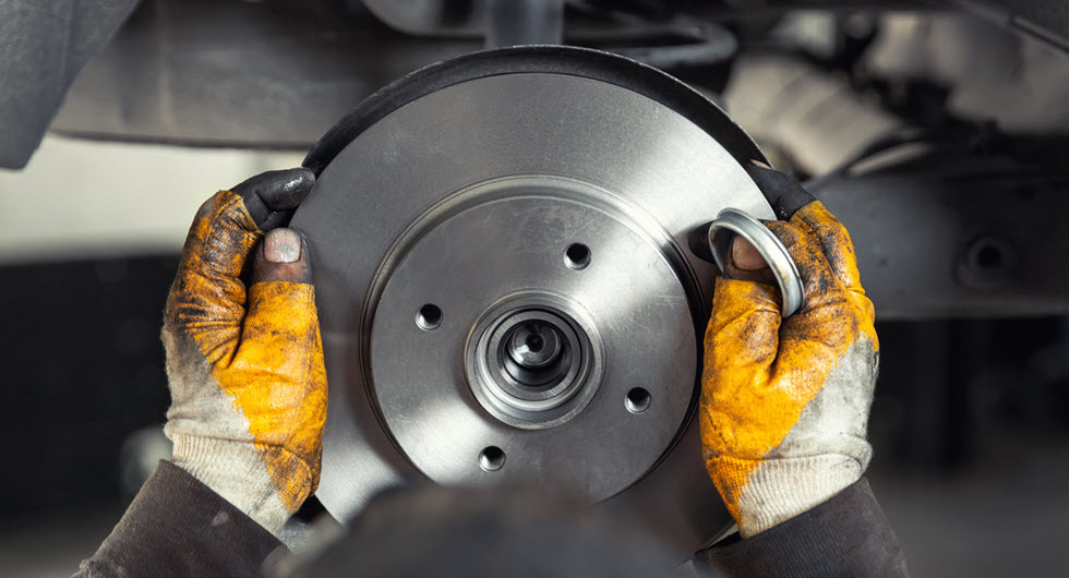 Car Mechanic Installing New Brake Rotor