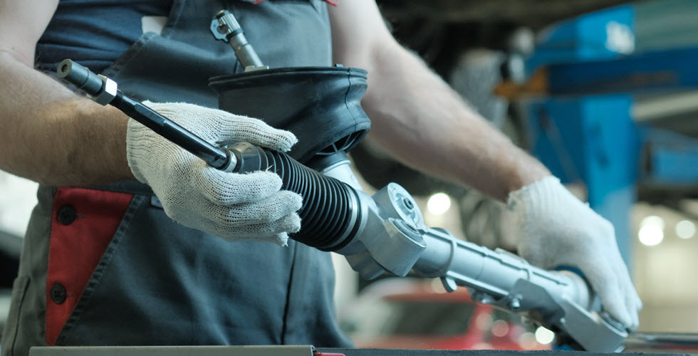 Auto Mechanic Holding New Steering Rack