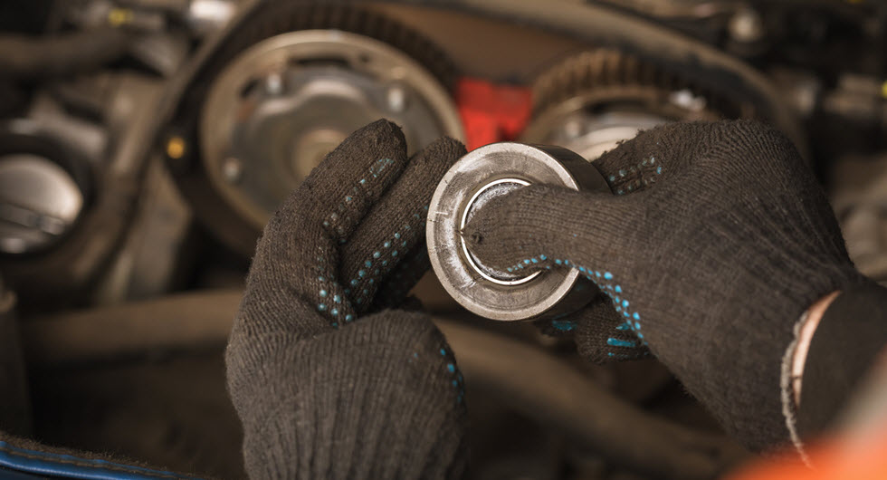 Auto Mechanic Checking Timing Belt Tensioner Roller